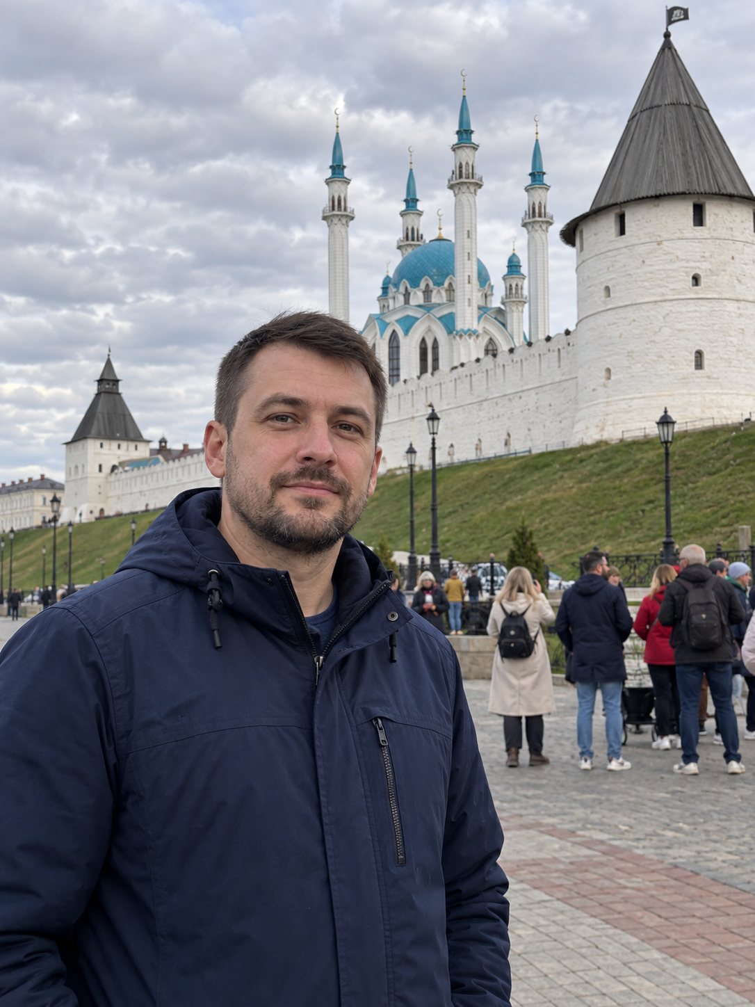 До — мужчина на фоне Казанского кремля, позади толпа туристов